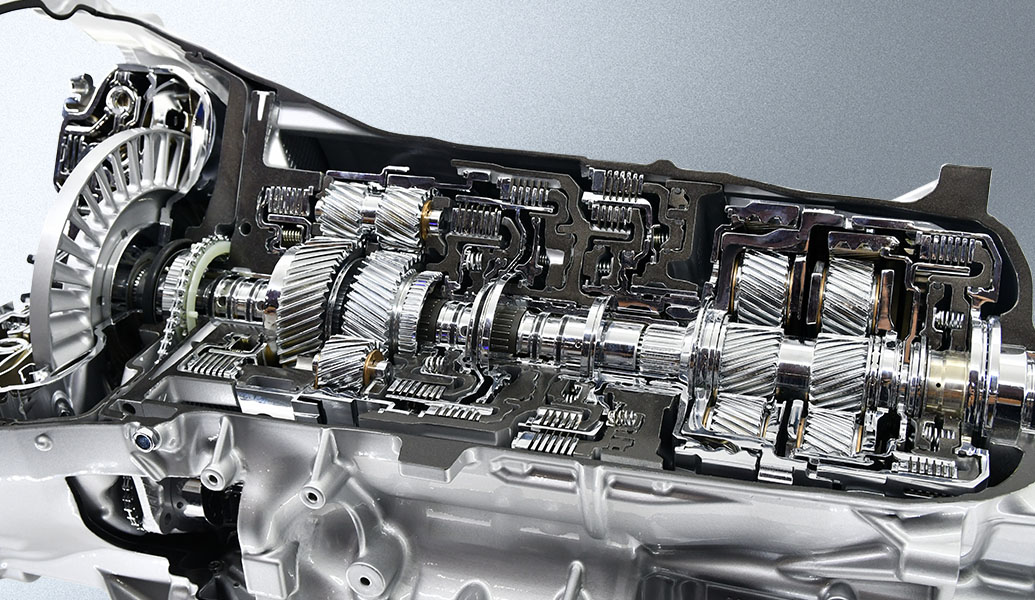 This image showcases a cross-section of a complex mechanical transmission system, revealing an intricate arrangement of gears, shafts, and bearings in metallic tones.